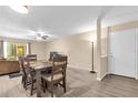 Open dining area with wood-look flooring, ceiling fan, and view to the living room at 4102 Plantation Cove Dr # 201, Orlando, FL 32810