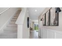 Bright hallway with staircase leading to upstairs and views of the outdoors at 4616 Linda Dr, Lake Wales, FL 33859