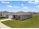 Well-kept home boasting a cozy design, landscaped yard, and paved driveway at 489 Panaro Ln, Haines City, FL 33844