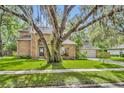 Beautiful brick house with an inviting front yard and mature shade trees at 5430 Baytowne Pl, Oviedo, FL 32765