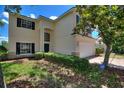Charming two-story home with an attached garage, manicured lawn, and beautiful exterior features at 546 Windsor Pl, Davenport, FL 33896