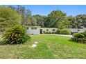 Charming single-story home with mature landscaping, including palm trees at 5815 Holmes Dr, Orlando, FL 32808