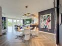 Modern dining room featuring stylish round table with white tulip chairs and vibrant artwork at 6336 Buford St # 207, Orlando, FL 32835