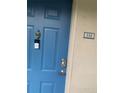Blue front door featuring door bell, door knocker, and unit number 114 at 7360 Westpointe Blvd # 114, Orlando, FL 32835