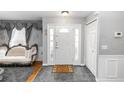 Elegant foyer featuring neutral walls, tile flooring, and a decorative sofa for a grand entrance at 7642 Park Hill Ave, Leesburg, FL 34748
