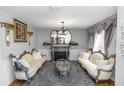 Ornate living room with a fireplace, decorative mirrors, and elegant sofas for sophisticated living at 7642 Park Hill Ave, Leesburg, FL 34748