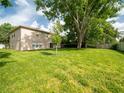Spacious backyard with lush green grass, mature trees, and a partially fenced-in area for privacy at 8330 Lainie Ln, Orlando, FL 32818