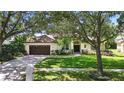 Inviting single-story home with well-maintained landscaping, a two-car garage, and a neatly manicured lawn at 9491 Wickham Way, Orlando, FL 32836