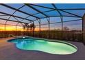 Sparkling screened-in pool and hot tub with sunset views, perfect for relaxation at 4111 Oaktree Dr, Davenport, FL 33837