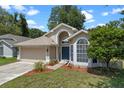 Attractive single-Gathering home with manicured lawn and mulched flower beds leading to the front entrance at 1021 Piedmont Oaks Dr, Apopka, FL 32703