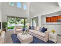 Bright living room featuring high ceilings, large windows with natural light, and stylish furniture at 1067 Chatham Break St, Orlando, FL 32828