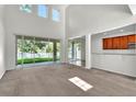 Bright living room featuring high ceilings and large windows providing natural light at 1067 Chatham Break St, Orlando, FL 32828