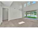 Bright living room featuring high ceilings and large windows overlooking the yard at 1067 Chatham Break St, Orlando, FL 32828