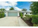 Attractive single-story home with a two-car garage, brick facade, and lush landscaping at 111 Woodstream Ct Ct, Maitland, FL 32751