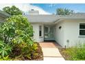 Inviting front entrance with brick accents, double doors, and vibrant landscaping creates a warm welcome at 111 Woodstream Ct Ct, Maitland, FL 32751