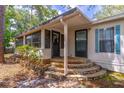 Inviting entrance with stone steps, a screened porch, and dual entry doors at 116 E Plantation Blvd, Lake Mary, FL 32746