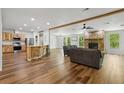 Open-concept living area with stone fireplace, bar seating, and plenty of natural light at 1235 Arapaho Trl, Geneva, FL 32732