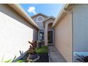 Inviting front entry featuring a decorative wreath and landscaped flowerbeds at 14831 Yorkshire Run Dr, Orlando, FL 32828