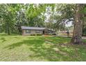 A cozy single-story house on a spacious lot, surrounded by mature trees offering plenty of shade and curb appeal at 1753 Nw 44Th St, Ocala, FL 34475