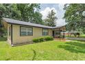 Charming single-story home with a well-manicured lawn and mature landscaping, enhanced by natural light and inviting curb appeal at 1753 Nw 44Th St, Ocala, FL 34475