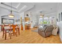 Open-concept living room boasting hardwood floors and abundant natural light at 195 River Village Drive, Debary, FL 32713