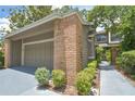 Brick home with an attached two-car garage, mature landscaping, and charming brick accents at 200 Hummingbird Ln, Longwood, FL 32779