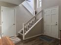 Bright foyer staircase with wooden steps, white banisters, and a neutral color scheme at 200 Hummingbird Ln, Longwood, FL 32779