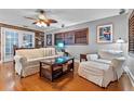 Cozy living room featuring hardwood floors, a ceiling fan, and a comfortable seating area at 2190 Temple Dr, Winter Park, FL 32789