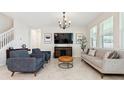 Modern living room featuring tile floors, comfortable seating, stylish furnishings and bright neutral colors at 2279 Mountain Pine St, Ocoee, FL 34761