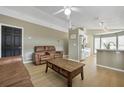 Open-concept living room with modern furnishings and seamless flow to the kitchen area at 2308 Donegan Pl, Orlando, FL 32826