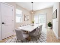 Bright dining room with a large marble table, stylish chairs, modern chandelier, and sliding glass doors at 317 Mandrake St, Orlando, FL 32811