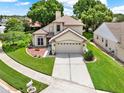 Beautiful home with manicured lawn, complemented by a two-car garage and a spacious driveway at 3561 Ventura Club Cir, Orlando, FL 32822