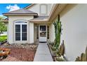 Inviting front entrance featuring a well-lit pathway and a decorative cactus at 3561 Ventura Club Cir, Orlando, FL 32822