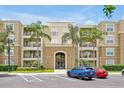 Inviting condo exterior with palm trees, well-kept landscaping, and convenient parking at 5024 Shoreway Loop # 10106, Orlando, FL 32819