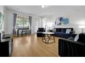 Bright living room featuring hardwood floors, modern furnishings, and large windows at 5024 Shoreway Loop # 10106, Orlando, FL 32819