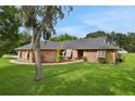 Beautiful single-story brick home with mature landscaping at 5929 Hatteras Dr, Port Orange, FL 32127