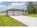 Beautiful single-story home showcasing a well-maintained lawn and a two-car garage at 6929 Sw 130Th Lane Rd, Ocala, FL 34473