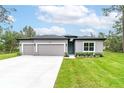 Charming single-story home featuring a two-car garage and a well-maintained lawn at 6929 Sw 130Th Lane Rd, Ocala, FL 34473