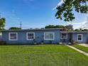 Charming single-story home with well-maintained lawn, freshly painted exterior, and freshly cemented driveway at 7033 Lakner Way, Orlando, FL 32822