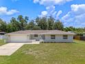 Beautiful home featuring a freshly manicured lawn and a spacious two-car garage at 7360 Canal Dr, Sanford, FL 32771