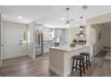 Modern kitchen featuring stainless steel appliances, a breakfast bar, and pendant lighting at 7360 Canal Dr, Sanford, FL 32771