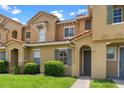 Inviting townhome showcasing a well-maintained lawn and beautiful terra cotta roof at 7625 Long Island Dr, Kissimmee, FL 34747
