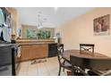 Bright kitchen and breakfast area with light cabinets, tile flooring, and sliding door access at 7625 Long Island Dr, Kissimmee, FL 34747