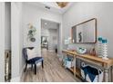 Elegant foyer featuring wood-look tile, console table, and stylish mirror and decor at 7778 Four Seasons Blvd, Kissimmee, FL 34747