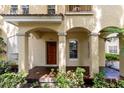 Close-up of the home's front door featuring stucco columns and mature plants at 820 Ellwood Ave # A, Orlando, FL 32804