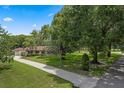 Lush landscaping and mature trees frame this home, offering a peaceful and private setting at 9601 Ambleside Dr, Windermere, FL 34786