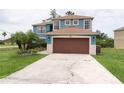 Two-story home with two-car garage and neutral exterior at 1001 Dampierre Ct, Kissimmee, FL 34759
