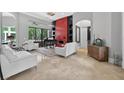 Bright and airy living room with tile floors, a grand piano, and modern decor at 11015 Hawkshead Ct, Windermere, FL 34786