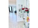 Inviting entryway with hardwood floors and elegant decorations on a mirrored console table at 11408 Satire St, Orlando, FL 32832