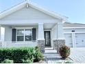 Beautiful home exterior with a covered porch and a two-car garage at 11408 Satire St, Orlando, FL 32832